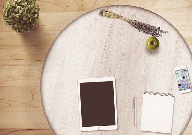 Ipad, notepad, apple on table. Choose the right words for your small business.